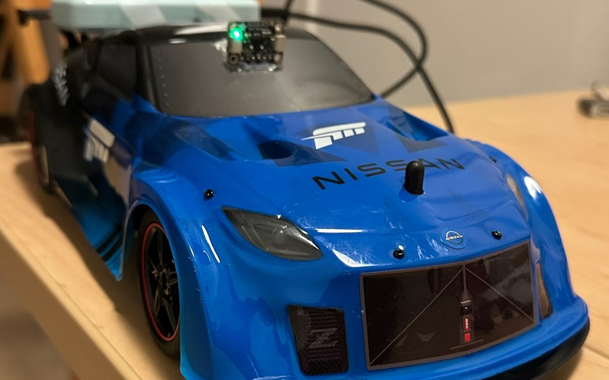 RC race car with a custom ESP32 control board mounted on the hood